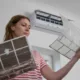 woman changing air filter in ac